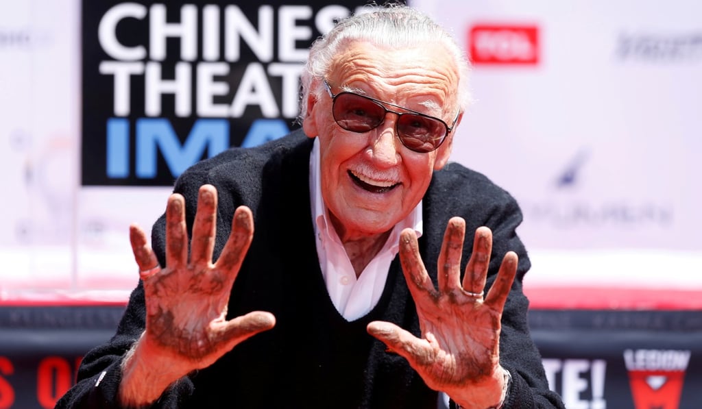 Stan Lee shows his hands after placing them in cement during a ceremony in Los Angeles in July 2017. Photo: Reuters