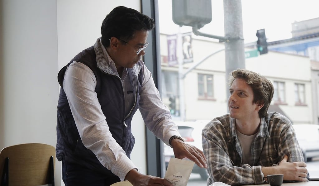 Klatch Coffee owner Bo Thiara, left, talks with customer Daniel Karel while giving Karel a tasting of Elida Natural Geisha coffee. Photo: AP