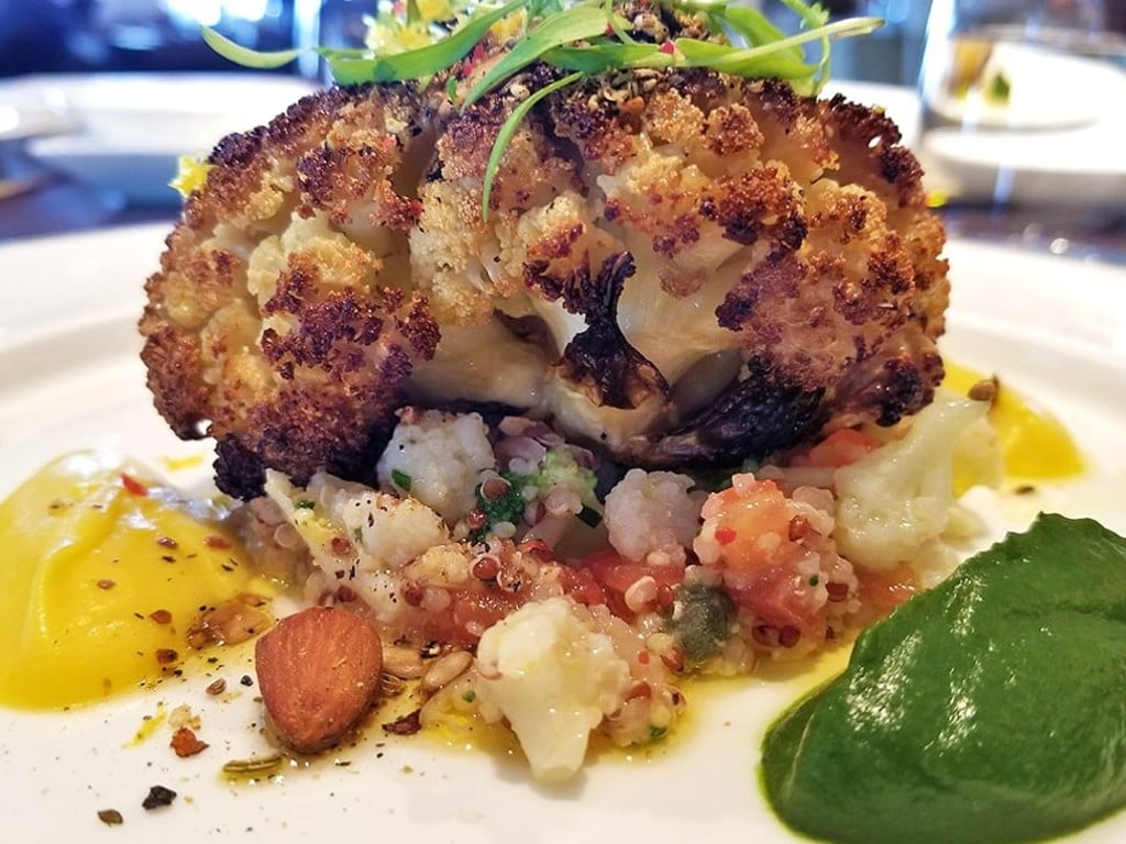 Whole roasted cauliflower is one of the vegan dishes served at Café Gray Deluxe. Whole roasted cauliflower is one of the vegan dishes served at Café Gray Deluxe.
