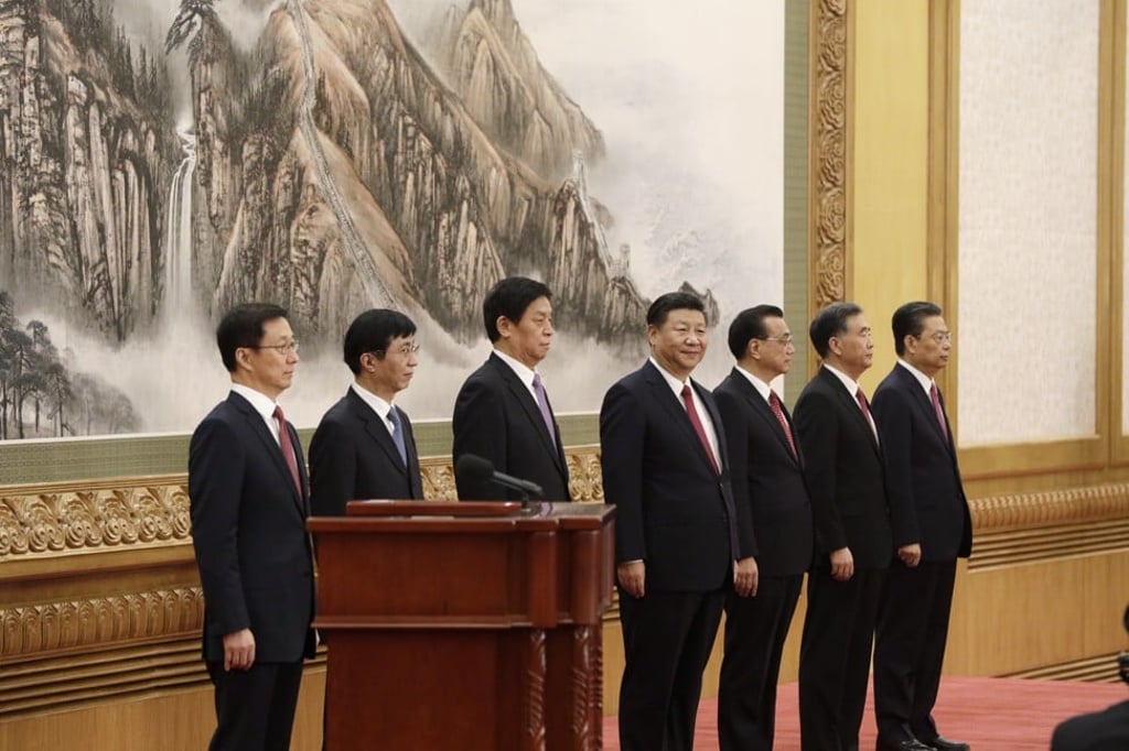 Members of the Communist Party of China's new Politburo Standing Committee Han Zheng, from left, Wang Huning, Li Zhanshu, Xi Jinping, Li Keqiang, Wang Yang and Zhao Leji stand on stage in the East Hall of the Great Hall of the People in Beijing, China. Photo: Bloomberg