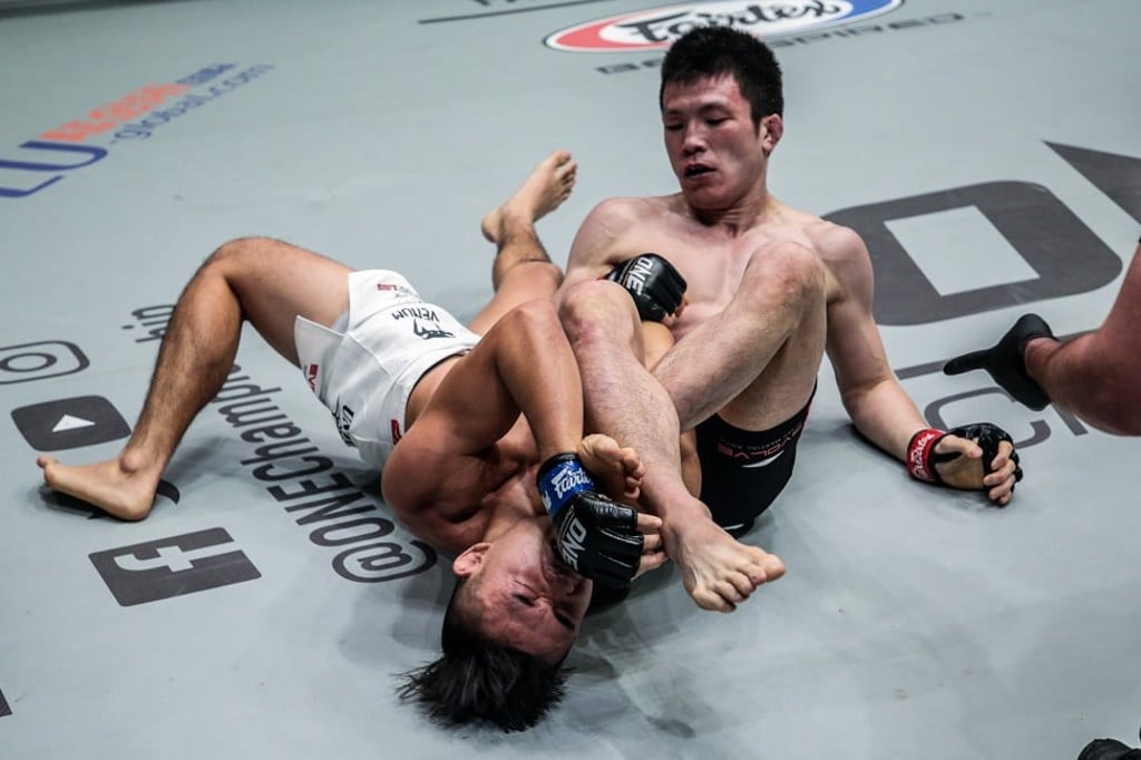Shinya Aoki looks for the armbar submission. Photo: One Championship