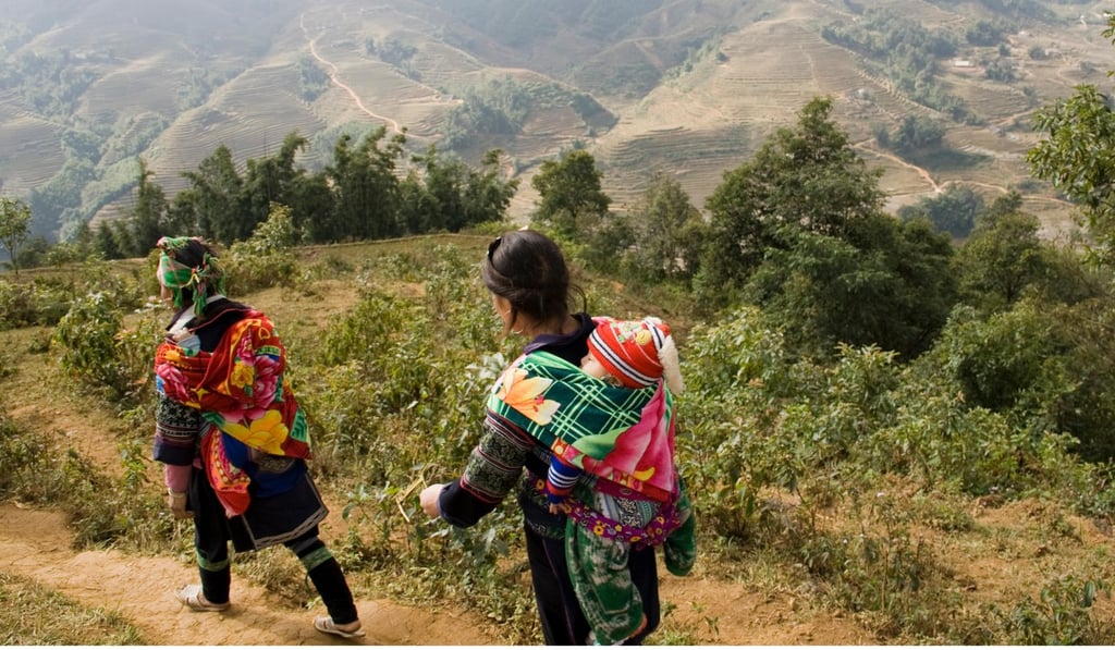 Two women in traditional Vietnamese dress walk down a trail in Sapa. Photo: Nam Cheah