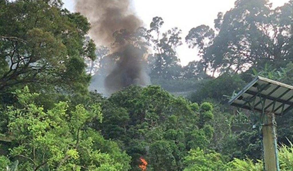 Smoke is seen near Kadoorie Farm in Hong Kong after a helicopter crashed on Sunday night. Photo: Facebook Smoke is seen near Kadoorie Farm in Hong Kong after a helicopter crashed on Sunday night. Photo: Facebook