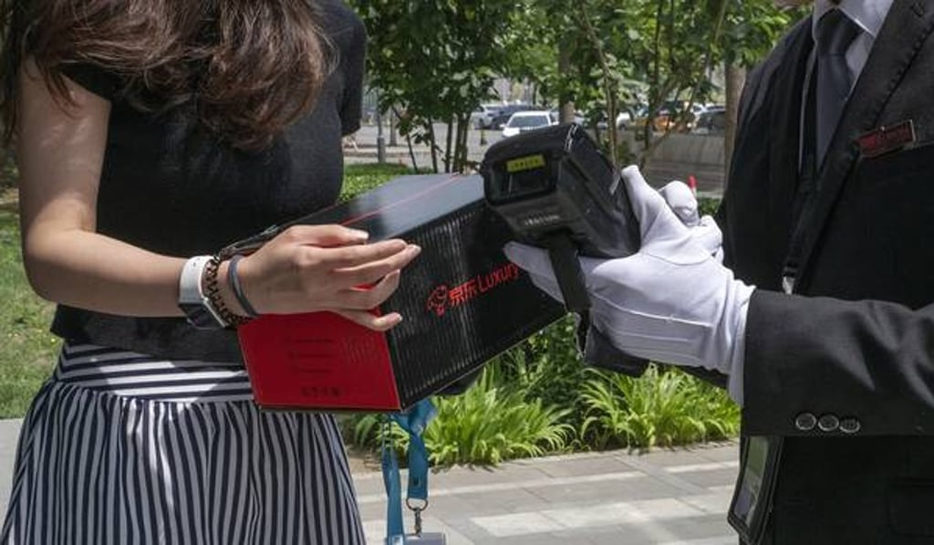 A customer in China receives her online order. Photo: Gilles Sabrie