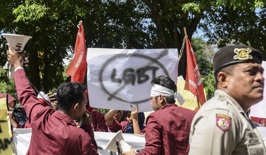 A group of Muslim protesters march with banners against the LGBT community in Banda Aceh in 2017. Photo: AFP