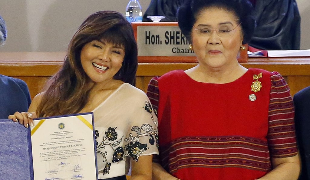 Imee Marcos (left), daughter of former Philippine dictator Ferdinand Marcos and first lady Imelda (right), holds her election certificate at a ceremony on Wednesday. Photo: AP