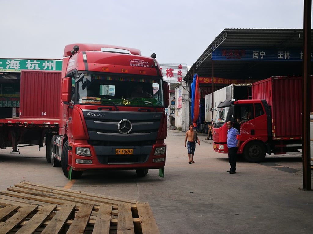 A truck park in a parking lot in Guangzhou. Logistics companies from China’s southern hub are facilitating the movement of plants out of China and into Southeast Asian countries. Photo: Huifeng He