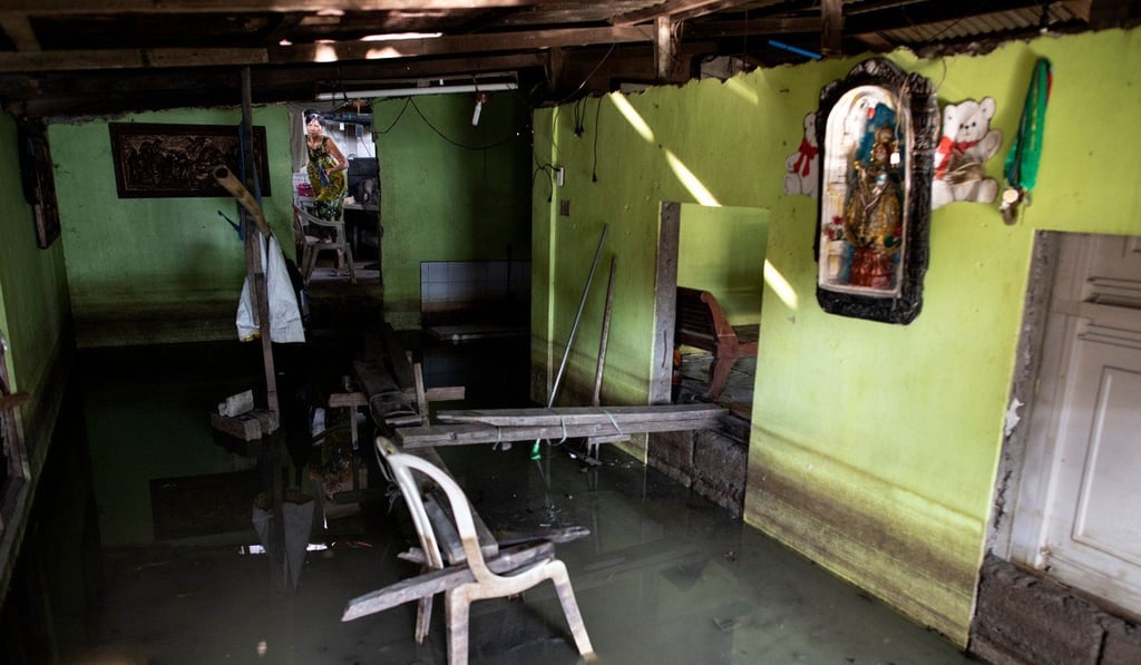 A woman inside a flooded house in Mabalacat, Pampanga. Photo: AFP A woman inside a flooded house in Mabalacat, Pampanga. Photo: AFP