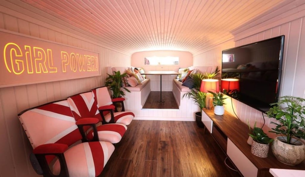 The living area of the Spice Bus, which features a row of matching Union flag cinema chairs. The living area of the Spice Bus, which features a row of matching Union flag cinema chairs.