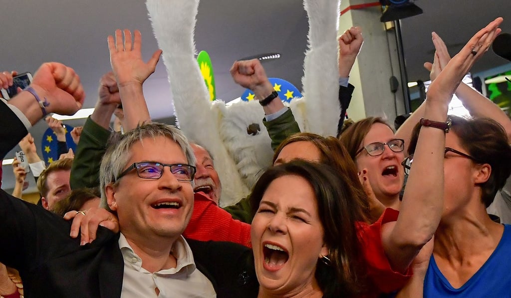 German Greens party top candidate Sven Giegold and co-leader Annalena Baerbock celebrate as exit polls are announced. Photo: AFP German Greens party top candidate Sven Giegold and co-leader Annalena Baerbock celebrate as exit polls are announced. Photo: AFP