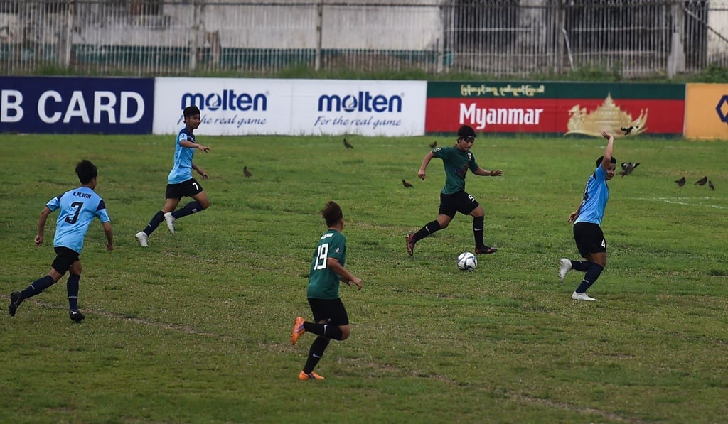 Myanmar’s under-19 player San Thaw Thaw (second right) running with the ball during a match at Aung San football stadium in Yangon. Photo: AFP