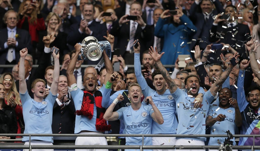 Manchester City’s team captain Vincent Kompany lifts the FA Cup. Photo: AP