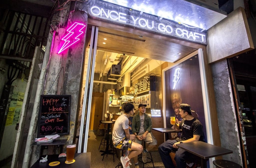 Darren Leung, owner of Once You Go Craft, chats with staff at his newly opened bar in Pok Man Street, Tai Kok Tsui. Photo: Christopher Dewolf Darren Leung, owner of Once You Go Craft, chats with staff at his newly opened bar in Pok Man Street, Tai Kok Tsui. Photo: Christopher Dewolf