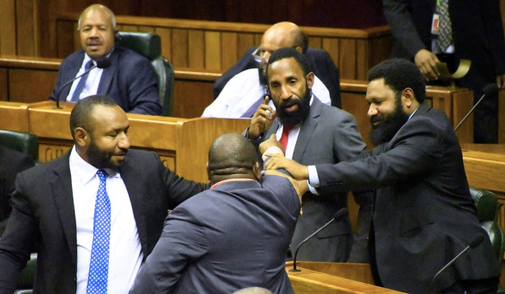Members of the parliament react as Peter O'Neill announced his resignation. Photo: AFP