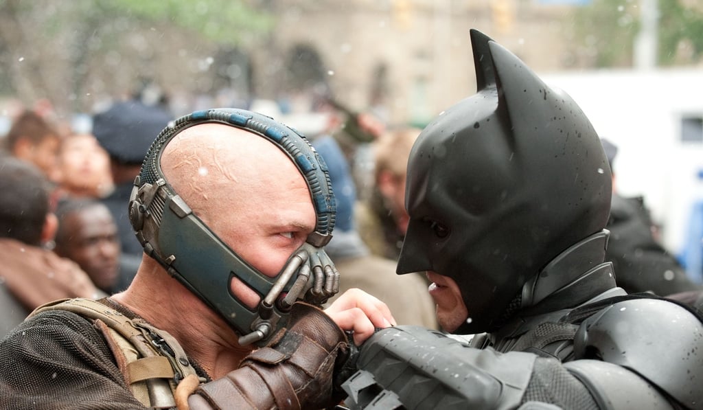 Tom Hardy as Bane and Christian Bale as Batman face off in The Dark Knight Rises. Hardy will have big shoes to fill if he plays Marvel’s new Wolverine after Hugh Jackman’s long and successful reign.