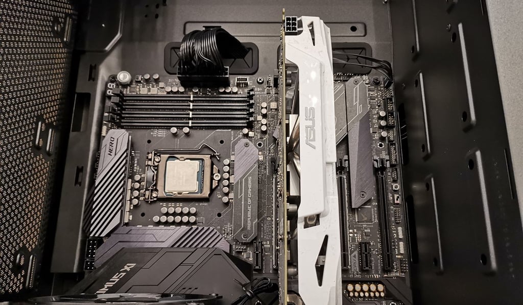 An Asus Maximus XI series gaming motherboard with Intel CPU (centre), and four empty RAM slots (right). Photo: Paul Mah An Asus Maximus XI series gaming motherboard with Intel CPU (centre), and four empty RAM slots (right). Photo: Paul Mah