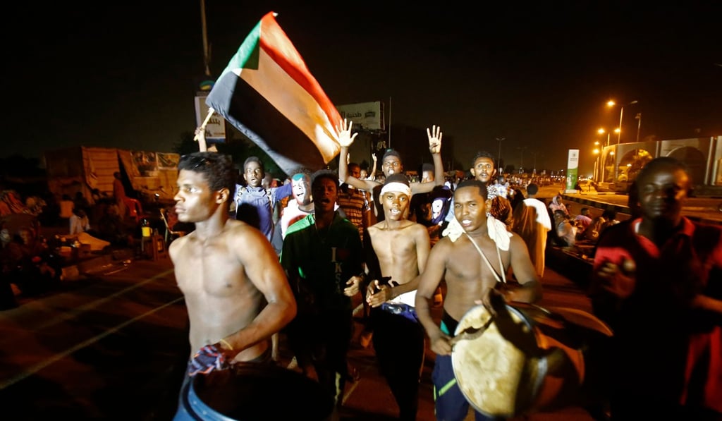Sudanese wave flags and chant slogans as they gather during a demonstration outside the army headquarters in Khartoum. Photo: AFP Sudanese wave flags and chant slogans as they gather during a demonstration outside the army headquarters in Khartoum. Photo: AFP