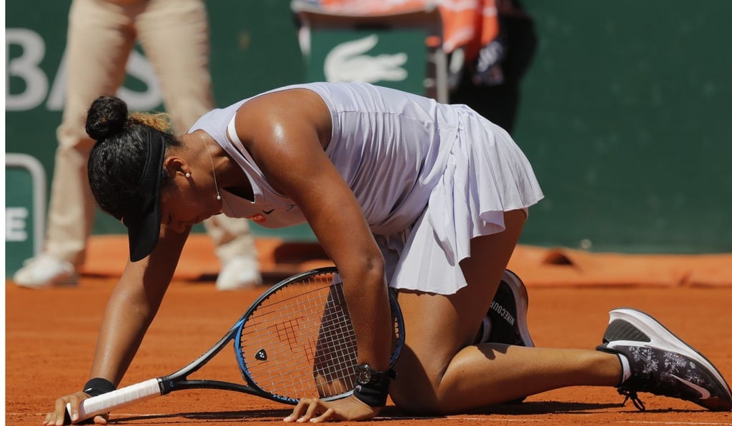 Naomi Osaka gets up after slipping during her third round match of the French Open. Photo: AP