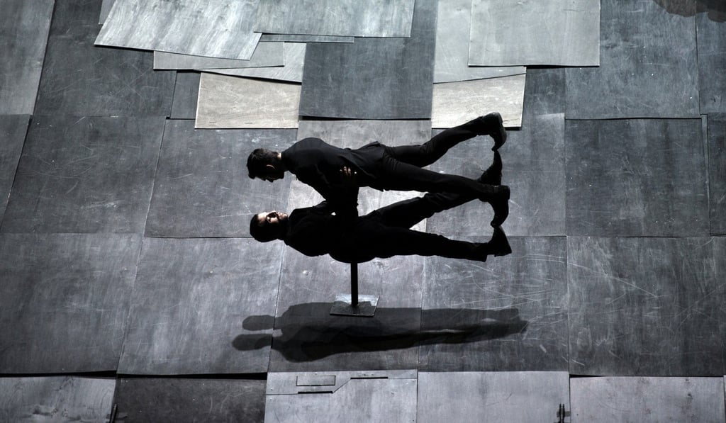 The stage of Dimitris Papaioannou’s ‘The Great Tamer’ is set on an incline and covered with removable charcoal grey plates that evoke the imagery of a cemetery. Photo: Julian Mommert The stage of Dimitris Papaioannou’s ‘The Great Tamer’ is set on an incline and covered with removable charcoal grey plates that evoke the imagery of a cemetery. Photo: Julian Mommert