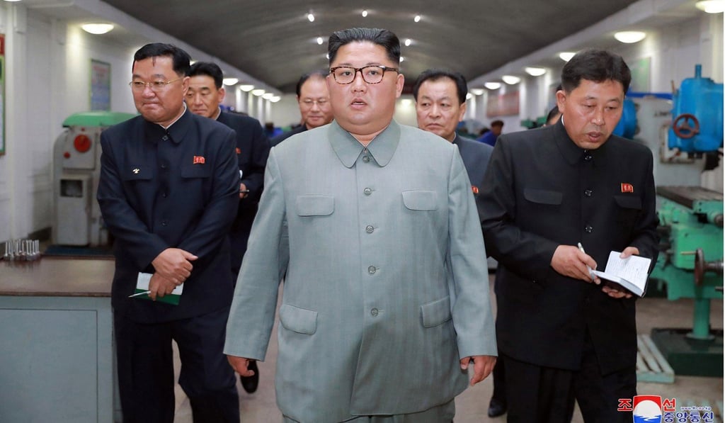 North Korean leader Kim Jong-un (centre) maintains an iron grip on the flow of people and information in and out of the country. Photo: AP