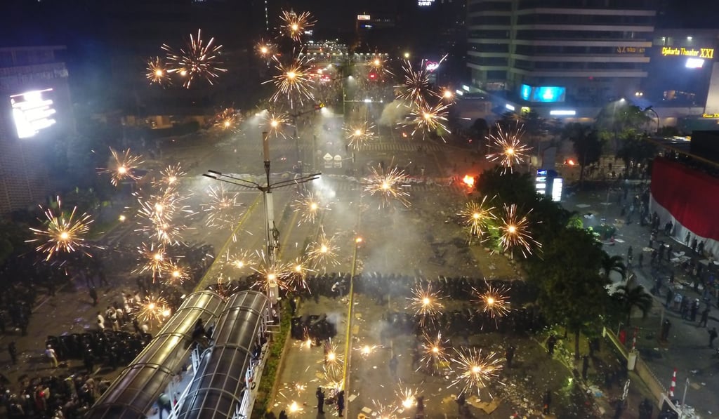 Demonstrators shoot fireworks at police officers during a protest over the election results. Photo: Bloomberg