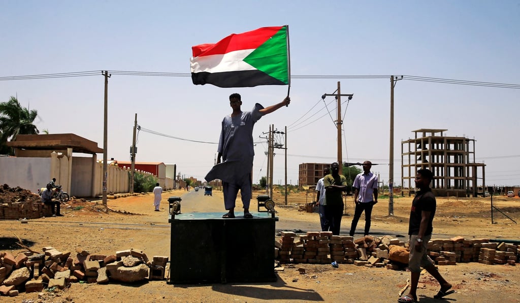 A Sudanese protester stands on a barricade in Khartoum, demanding that the country's Transitional Military Council hand over power to civilians. Photo: Reuters