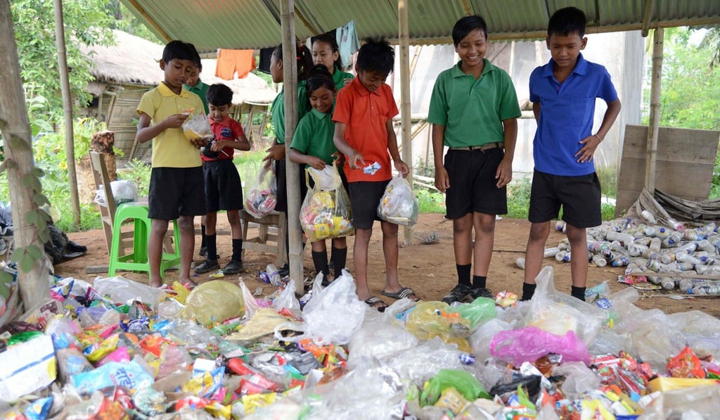 Pupils with the plastic waste they have gathered at the Akshar Forum school in Pamohi. Photo: AFP Pupils with the plastic waste they have gathered at the Akshar Forum school in Pamohi. Photo: AFP