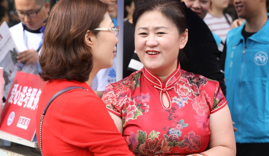 Wearing a traditional silk dress, known as a qipao, is considered lucky by some Chinese mothers. Photo: Simon Song