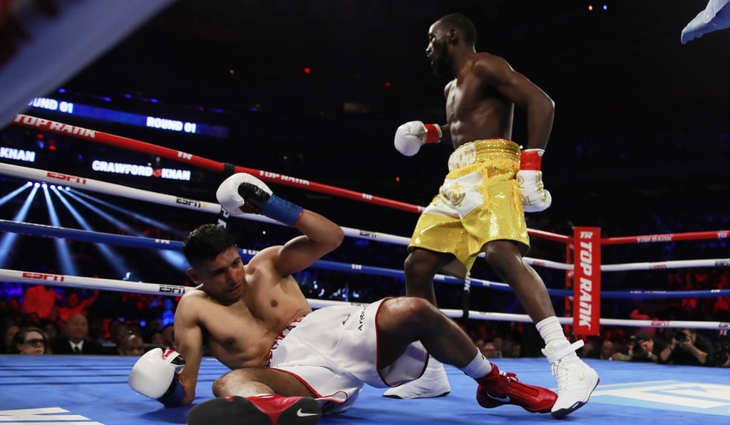 Terence Crawford knocks down Amir Khan. Photo: Reuters