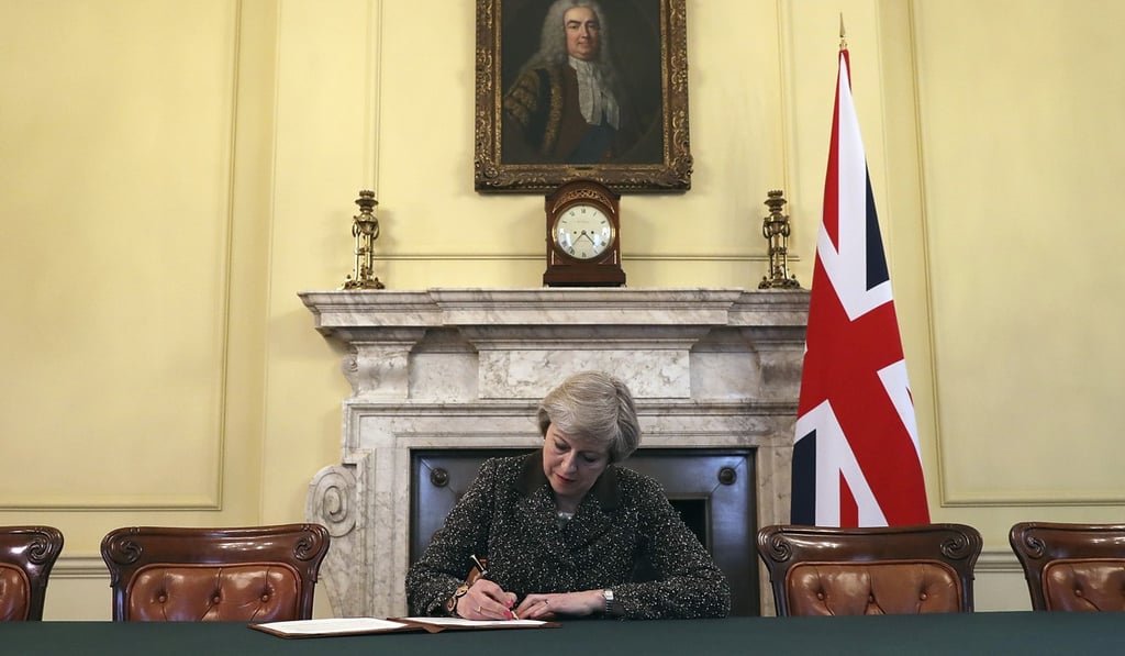 Britain's Prime Minister Theresa May in March 2017, signing the official letter to European Council President Donald Tusk invoking Article 50 of the bloc's key treaty, the formal start of Brexit negotiations. Photo: AP