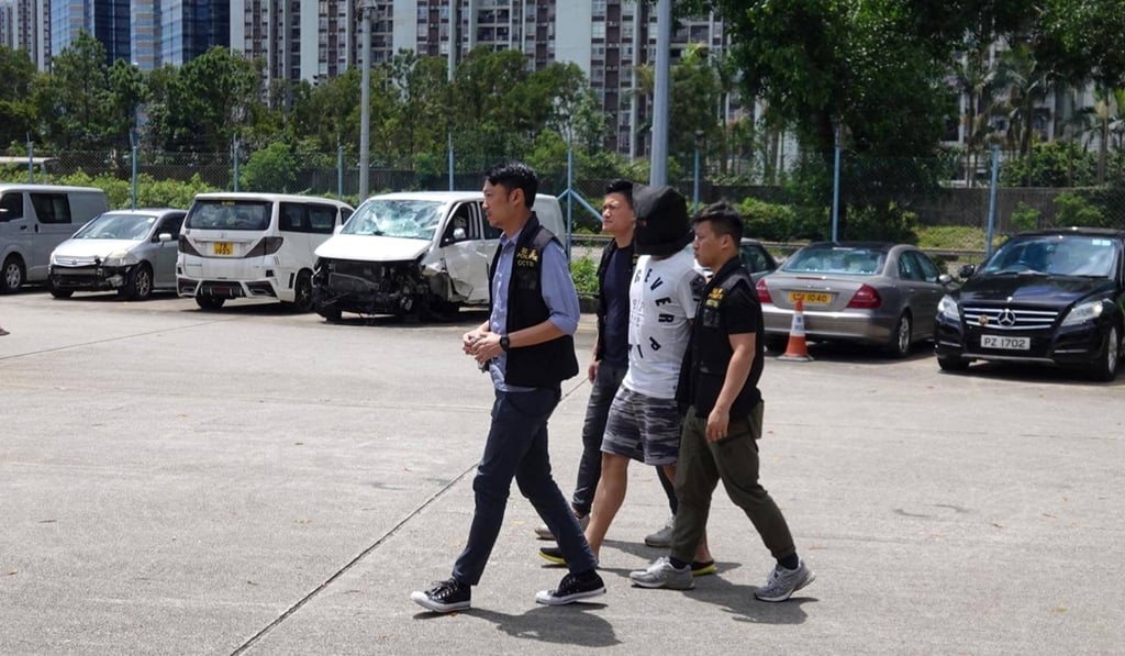 An arrested suspect from Friday’s petrol bombings is taken to a police vehicle yard on Saturday. Photo: Hong Kong Police Facebook