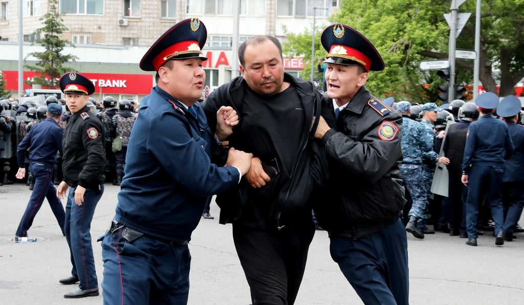 Police detain an opposition supporter during a protest on Sunday. Photo: EPA Police detain an opposition supporter during a protest on Sunday. Photo: EPA