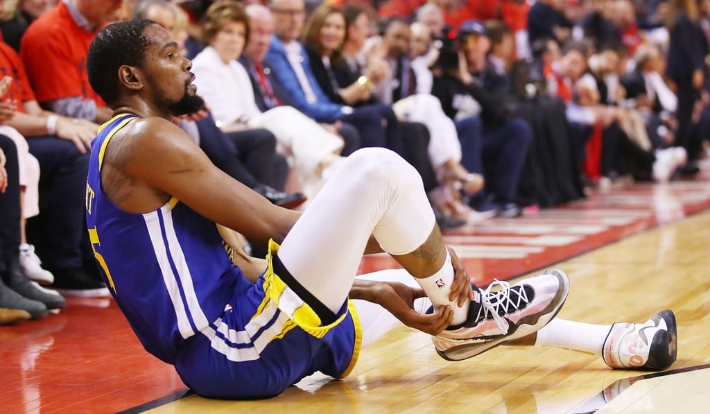 Kevin Durant goes down injured in the second quarter. Photo: AFP