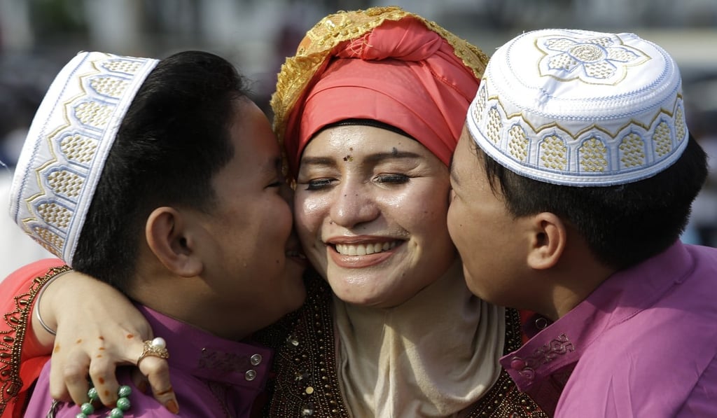 Filipino Muslim boys kiss their mother after Eid prayers in Manila. Photo: AP