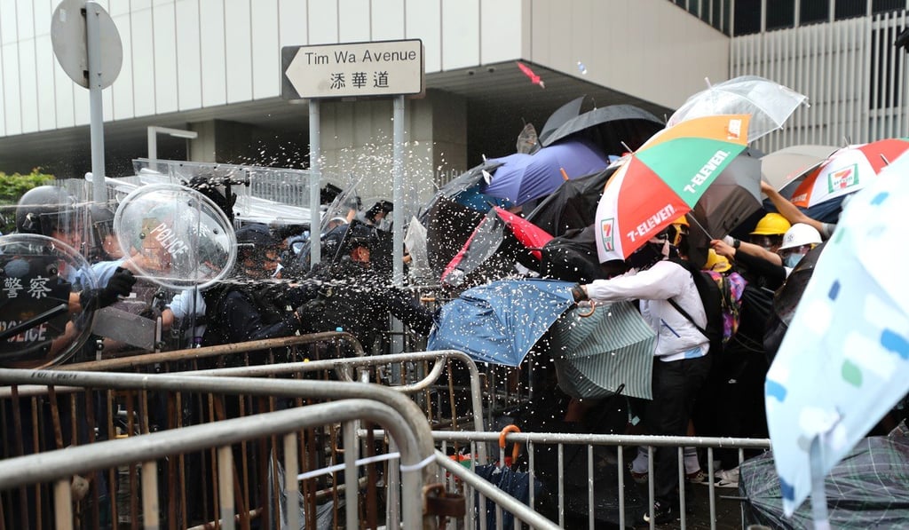 Anti-riot officers use pepper spray on a group of protesters in Tim Wa Avenue, Admiralty, on June 12. Photo: Sam Tsang