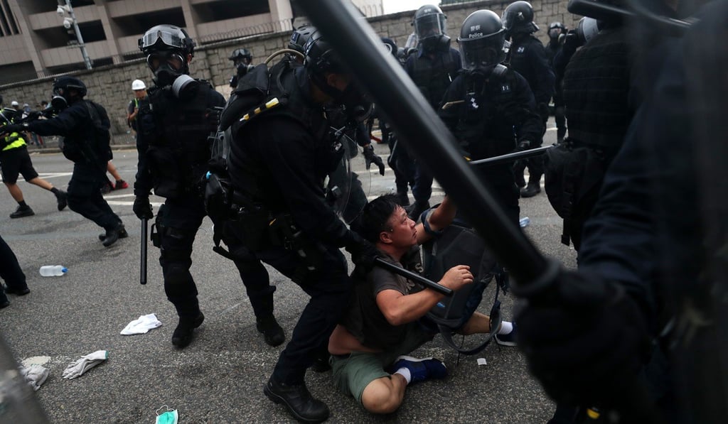 Anti-riot police officers restrain a protester on Harcourt Road in Admiralty on June 12. Photo: Sam Tsang