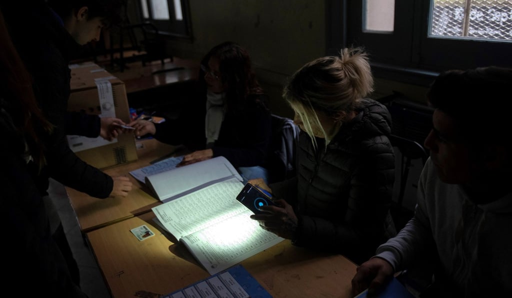 People vote in gubernatorial elections during a power outage in Rosario, Santa Fe province, Argentina, on Sunday. Photo: EPA People vote in gubernatorial elections during a power outage in Rosario, Santa Fe province, Argentina, on Sunday. Photo: EPA