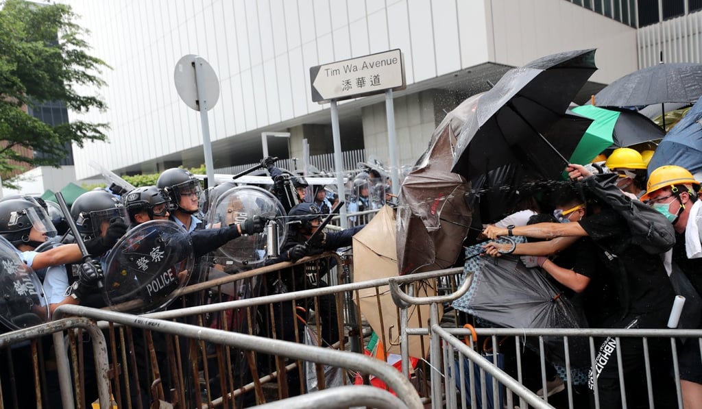Police officers use pepper spray on protesters on Wednesday, in a series of clashes that led to accusations the police used excessive force. Photo: Sam Tsang