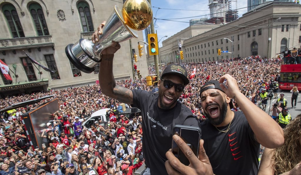 Kawhi Leonard holds his MVP trophy while celebrating with rapper Drake during the team's NBA basketball championship parade in Toronto on Monday. Photo: The Canadian Press via AP Kawhi Leonard holds his MVP trophy while celebrating with rapper Drake during the team's NBA basketball championship parade in Toronto on Monday. Photo: The Canadian Press via AP