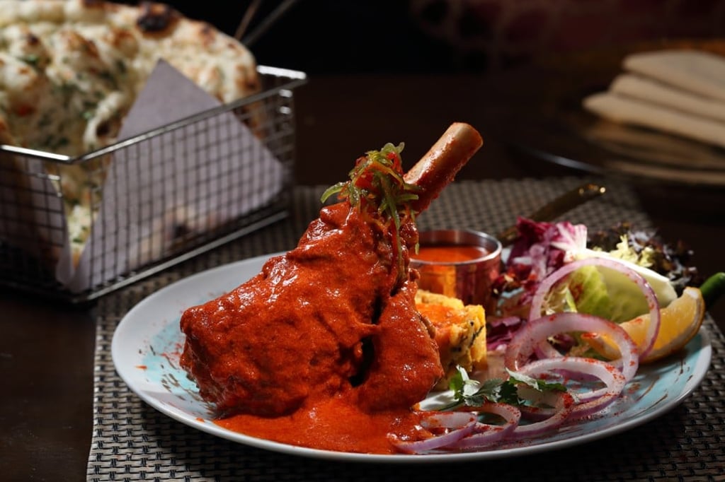 Slow-cooked braised spicy lamb shank paired with mashed potato masala and rogan josh sauce, created by chef Harpal Singh Sokhi at Jashan
