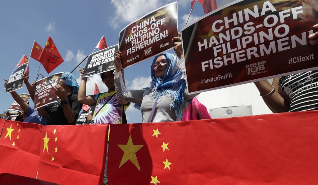 Protesters at Manila’s Rizal Park demonstrate against the sinking of a Filipino fishing boat in the South China Sea – as well as their president’s “weak” response to the incident. Photo: AP
