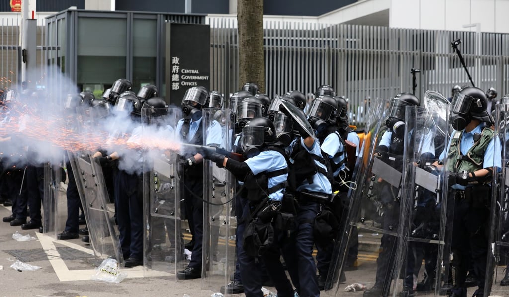 Police officers fire a tear-gas canister to disperse the crowd of anti-extradition protesters on June 12. Photo: Sam Tsang Police officers fire a tear-gas canister to disperse the crowd of anti-extradition protesters on June 12. Photo: Sam Tsang