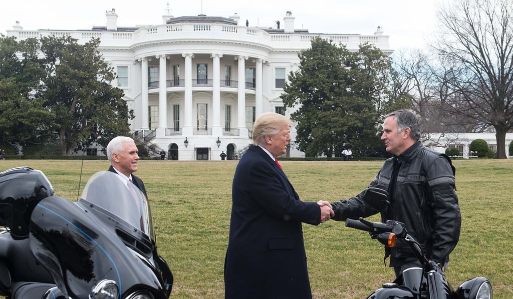 United States President Donald Trump greets Harley-Davidson CEO Matthew Levatich as he arrives with Vice President Mike Pence (L) to meet with Harley-Davidson executives and union representatives on the South Lawn of the White House in Washington, DC on February 2, 2017. Photo: AFP