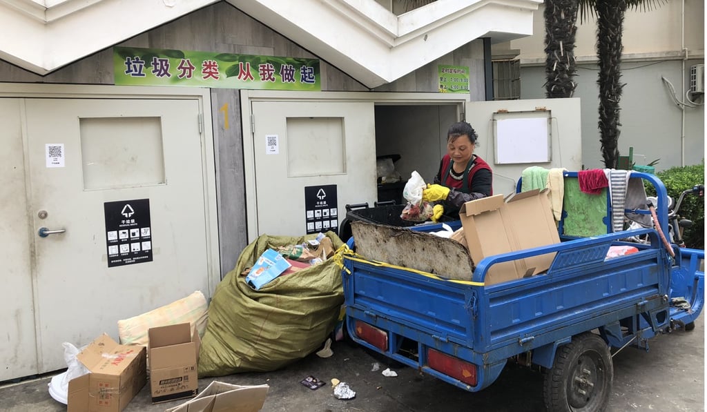 A cleaner re-sorts household waste at a residential facility in Shanghai. Photo: Alice Yan