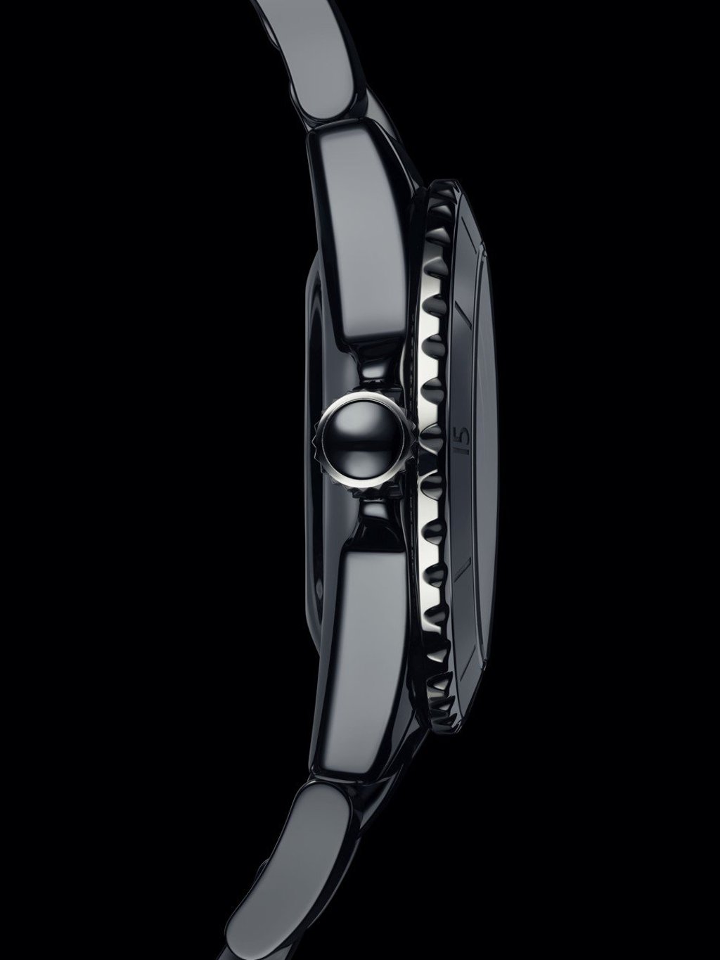 Chanel’s J12 timepiece features a screw-down crown, topped with a ceramic cabochon, and a steel lacquered dial.