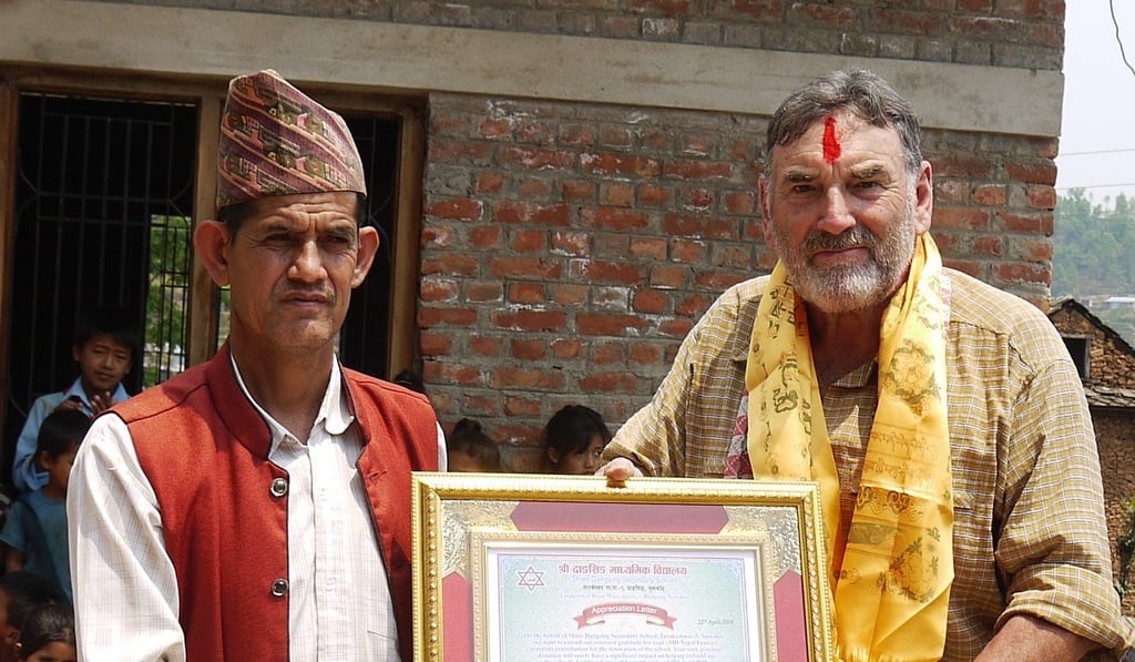Roy Francis receiving thank you letter from village leader, Dangsing.