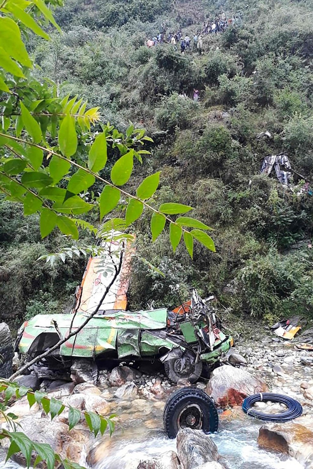 The remains of a bus carrying some 50 passengers after it fell into a 150-metre gorge. Photo: AFP