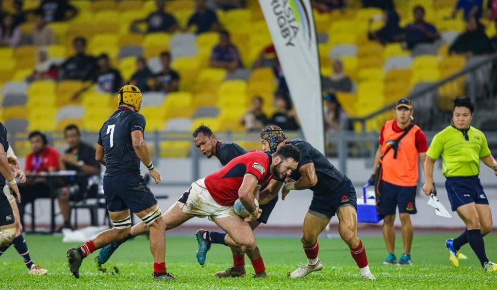 Conor Hartley breaks through the Malaysian line during Asia Rugby Championship play. Photo: Tiger Super Sports