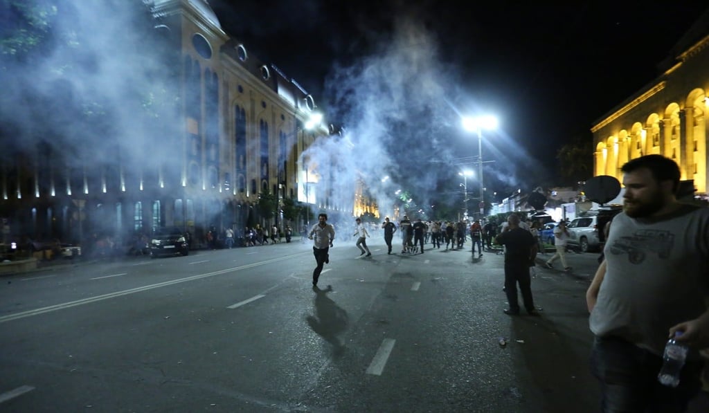 Protestors clash with riot police during a mass rally in front of the Parliament building in Tbilisi. Photo: EPA-EFE
