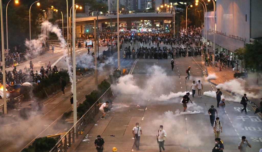Anti-extradition bill protesters flee from clouds of tear gas on June 12. Photo: Nora Tam
